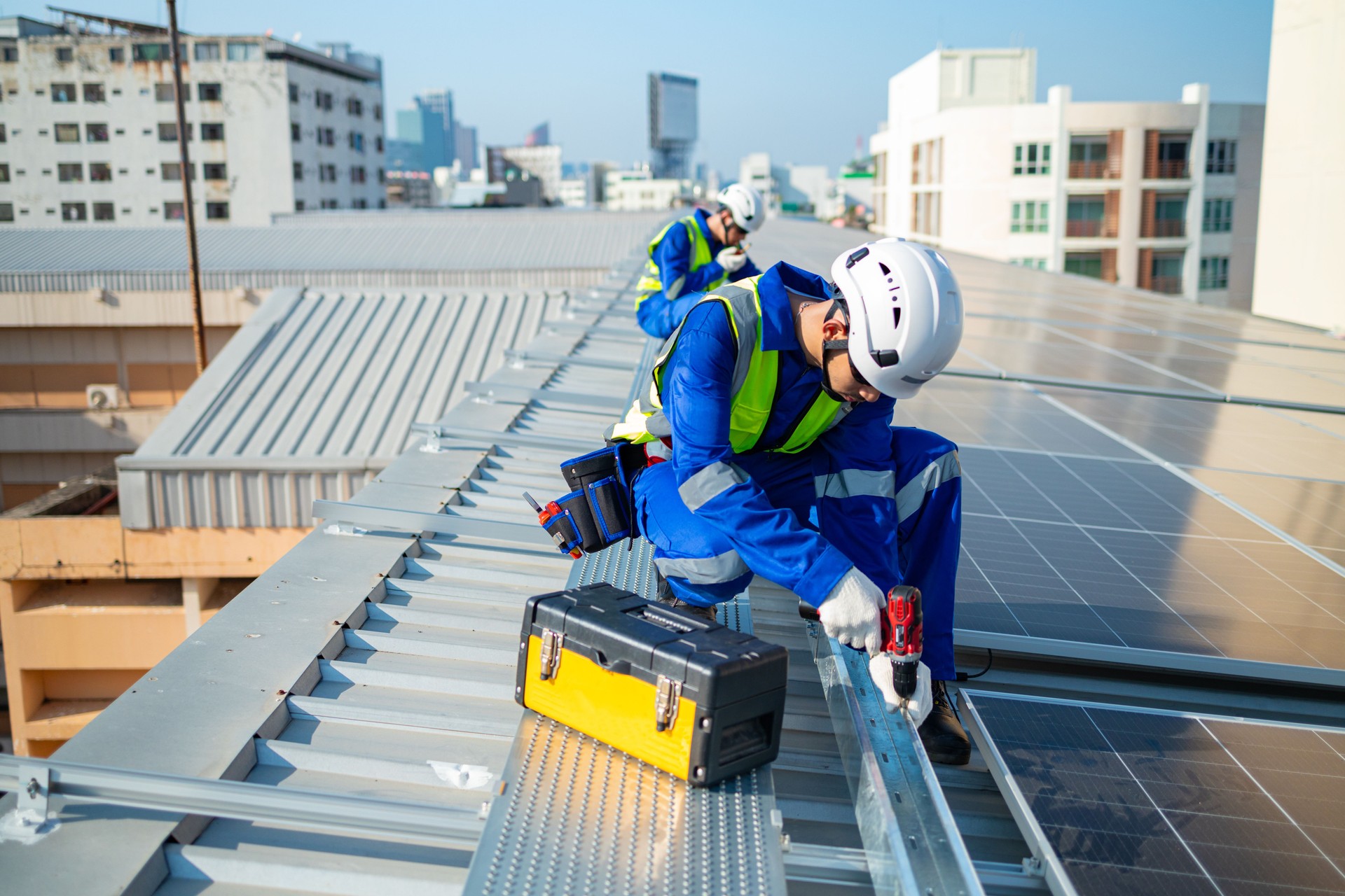Technicians Installing Solar Panels on Roof